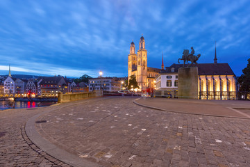 Famous Grossmunster churche along river Limmat at night in Old Town of Zurich, the largest city in Switzerland