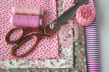 Natural fabric. Scissors and thread. Concept sewing cotton clothes, eco-friendly sewing.