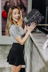 Smiling girl with shopping bags in shop