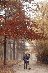 Obraz premium Happy interracial couple posing in autumn park