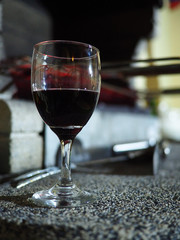 Red wine in elegant glass on blurred background