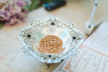 golden rings in grain at ceremony