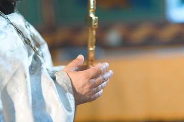 hand of priest at church ceremony