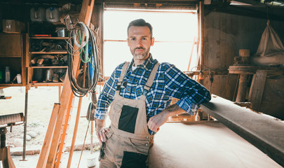 Portrait of middle aged carpenter in the carpentry workshop