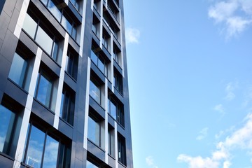 Modern office building facade abstract fragment, shiny windows in steel structure