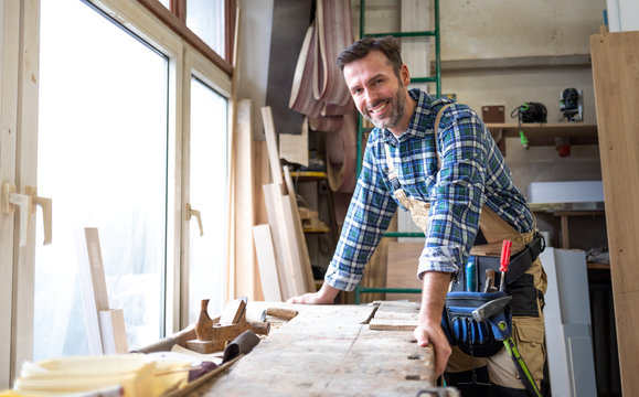 Portrait of middle aged carpenter in the carpentry workshop
