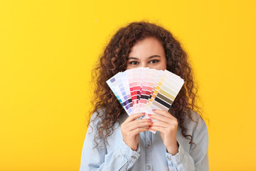 African-American woman with color palettes on yellow background