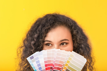 African-American woman with color palettes on yellow background