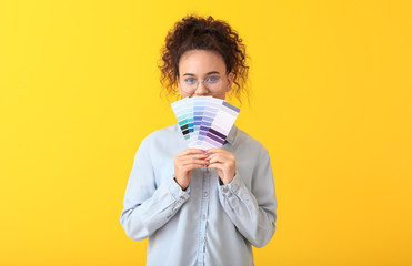 African-American woman with color palettes on yellow background