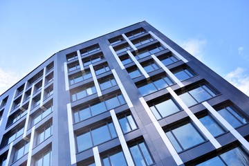 Modern office building facade abstract fragment, shiny windows in steel structure