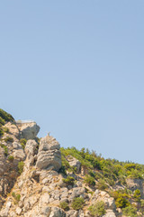 Mountains and rocks on the beach in summer on a Sunny day