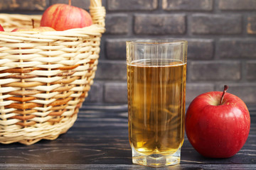 Glass of apple juice, red apple and juice
