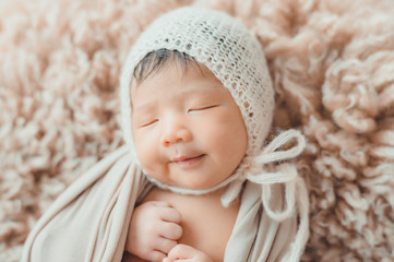Fototapeta na wymiar Cute newborn baby with knitted hat sleeping