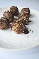 Homemade healthy vegan chocolate candies served on white plate