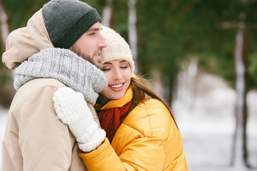 Happy young couple in park on winter day