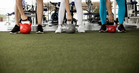 people working out with kettlebell in the gym