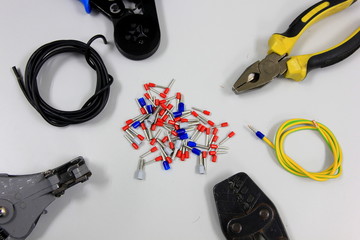 Tools for electrical wiring signal. Crimping tools, wire tips and electrical cable on white backgrounds.