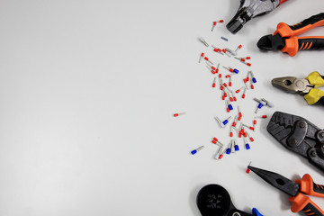 Tools for electrical wiring signal. Crimping tools, wire tips and electrical cable on white backgrounds.