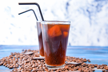 Glasses of tasty iced coffee on table