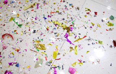 Multi-colored tinsel scattered on the tiled floor