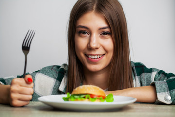 Nice girl wants to eat hamburger harmful