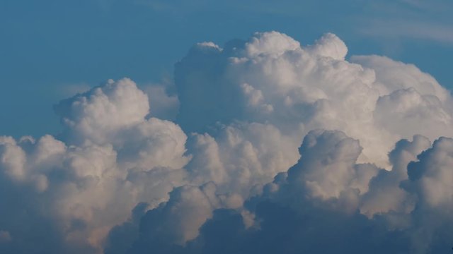 Timelapse: fluffy clouds, cumulus cloudscape moving over blue sky