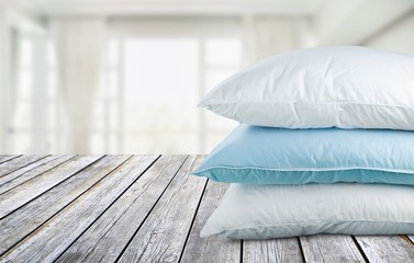 Soft pillows pile on wooden desk