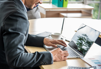 Young Asian Businessman working on laptop in the office