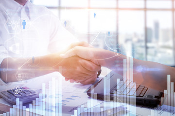 Double exposure of handshake and urban city,with business document.digital diagram chart and graph