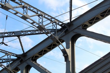 Structural elements of an old steel bridge. Arches and farms riveted.