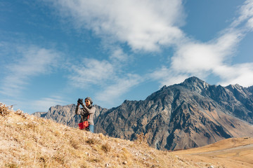 Fototapeta premium Woman tourist is taking a photo of mountain landscape.