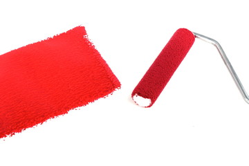red paint and painting roller on white background