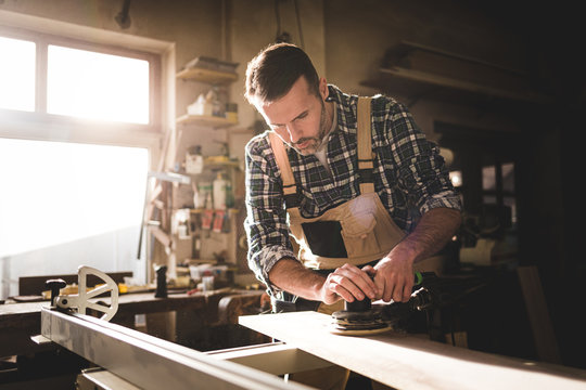 Carpenter working on woodworking in carpentry workshop