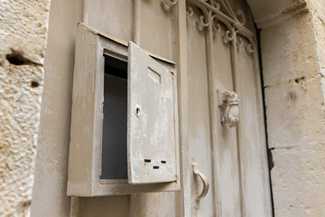 A metal mailbox hanging on metal gates in the old district of Jerusalem city in Israel