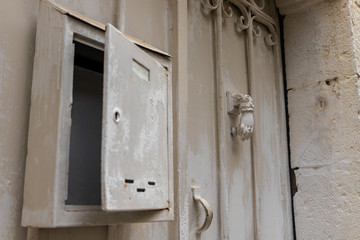 Decorative metal handle in the form of a hand, for knocking on gates hanging on metal gates in the old district of Jerusalem city in Israel