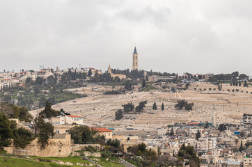 Fototapeta premium View of the old city of Jerusalem, jewish cemetery and the The Russian Church on Mount Eleon from the Abu Tor district of Jerusalem city in Israel