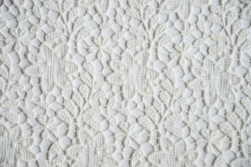 texture of white openwork fabric on a white background.