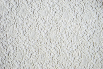 texture of white openwork fabric on a white background.