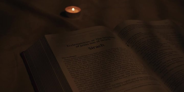 Open bible with candle 