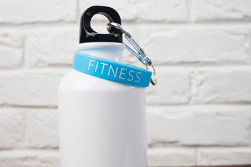 sports white water bottle for running and fitness on a brick background , the concept of sports and...