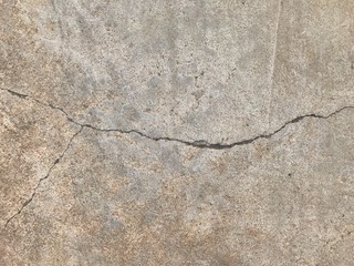 Grunge concrete cement floor with crack in industrial building. Cracked cement floor.