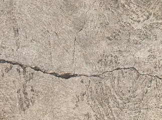 Grunge concrete cement floor with crack in industrial building. Cracked cement floor.