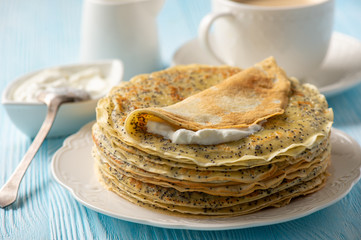 Poppy seed crepes, served with fraishe creme and jam.