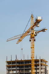 construction cranes against the blue sky	