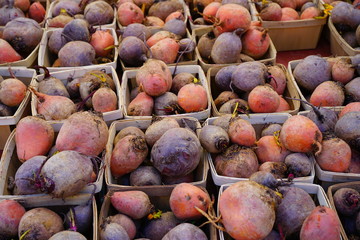 Containers of colorful beets at a farmers market