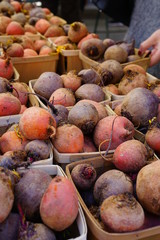 Containers of colorful beets at a farmers market