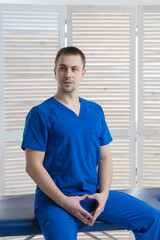 Portrait of a young male doctor in a medical office