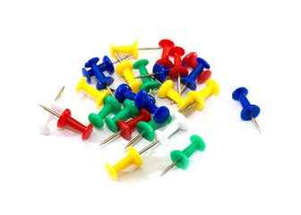 colored pins on a white background. Stationery.