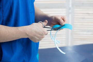 The doctor does the procedure of taping the spine for a young girl