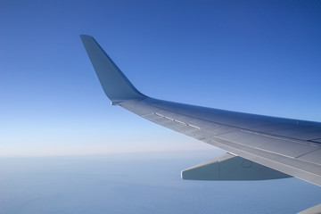 Fototapeta premium Airplane wing in the sky. View from a great height.